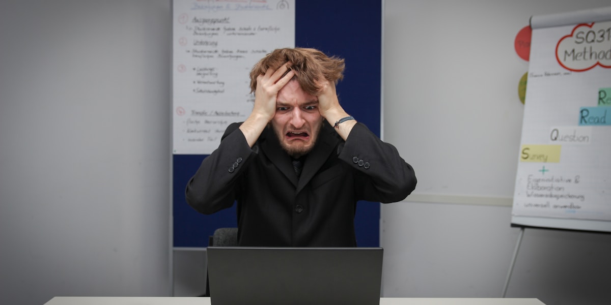 Frustrated person dealing with unemployment paperwork and health insurance documents, representing the challenges of finding coverage without traditional employment