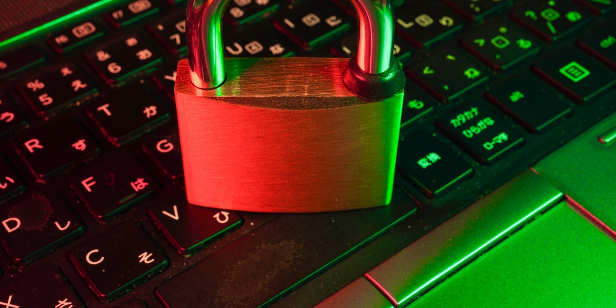 Red padlock on black computer keyboard representing cybersecurity protection against health insurance fraud and scams
