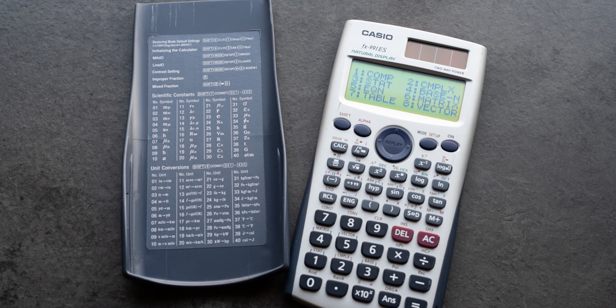 Calculator and tax forms on desk representing health insurance premium tax deductibility calculations and financial planning