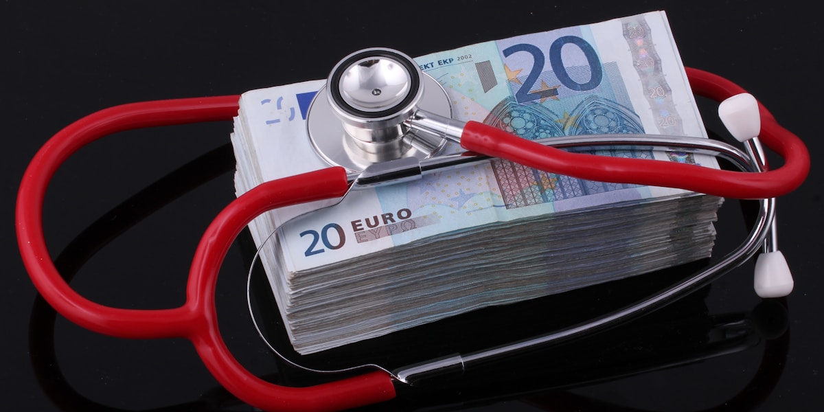 Stethoscope on currency representing medical billing costs